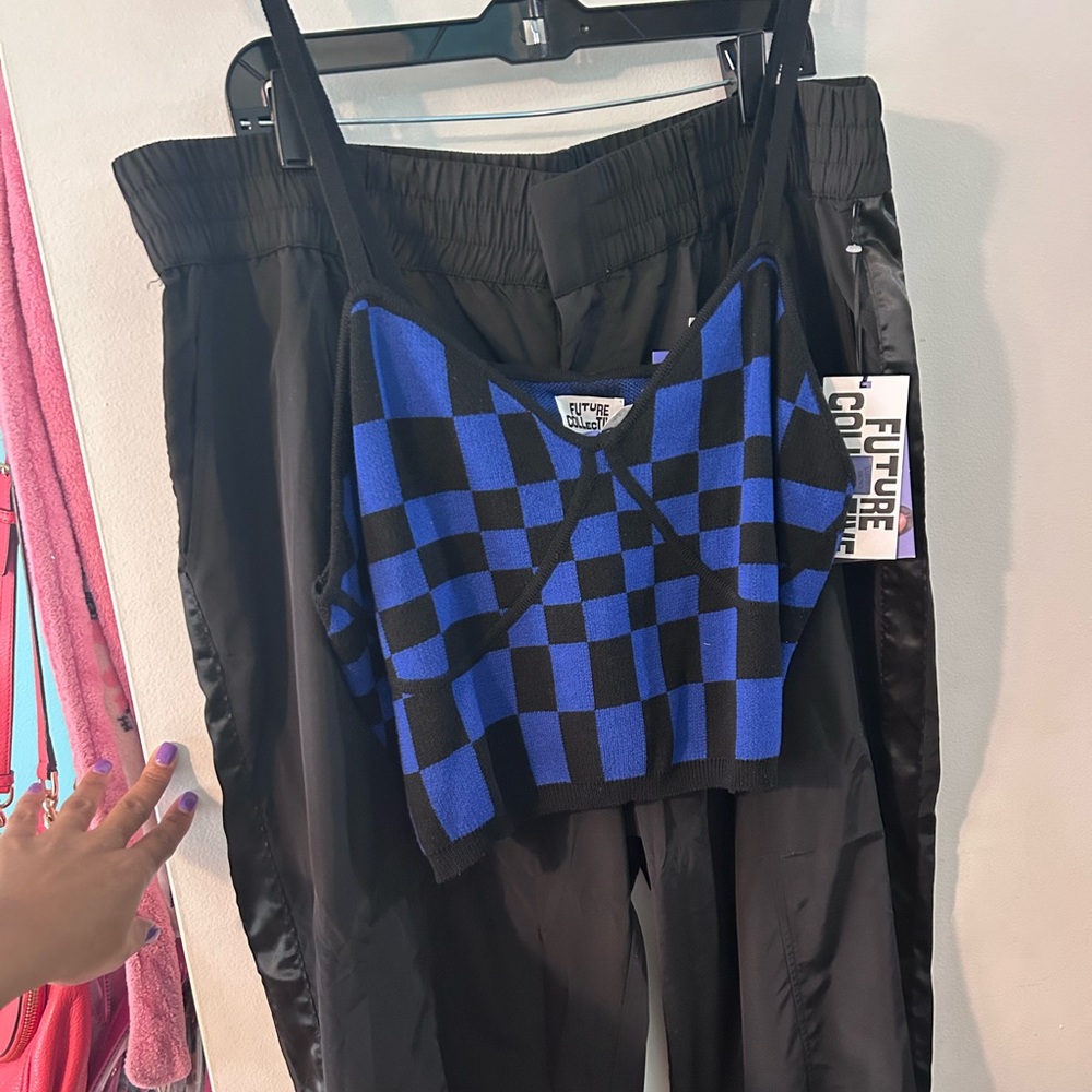 Cropped checkered tank with jogger windbreaker pants.